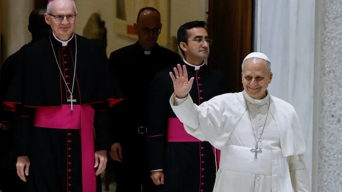 Pope Leo waves to attendees during a public audience at the Vatican after recovering from lung cancer surgery.