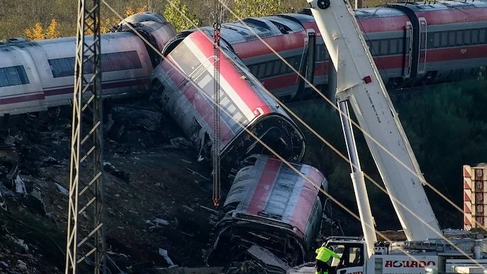 Rescue workers inspect mangled train carriages following a deadly high-speed railway collision in Spain.