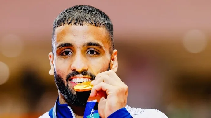 Sujeet Kalkal celebrates after winning wrestling gold at the Asian Games