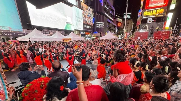 Crowds gather at New York’s Father Duffy Square for the second Times Square Durga Utsav featuring worship and cultural performances.