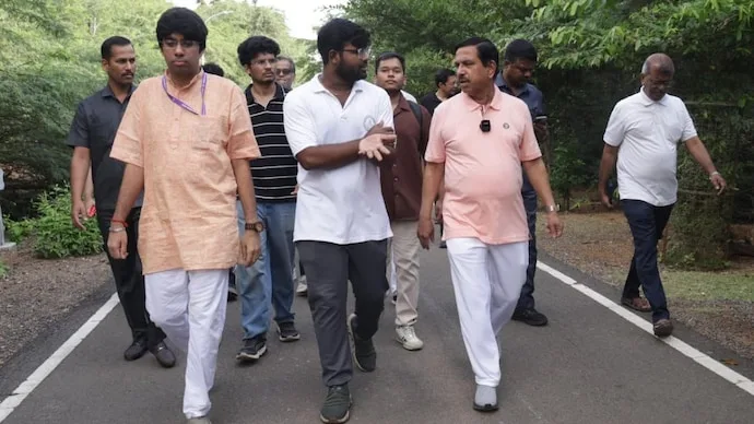 Education Minister Pralhad Joshi interacts with students during a morning walk at IIT Madras
