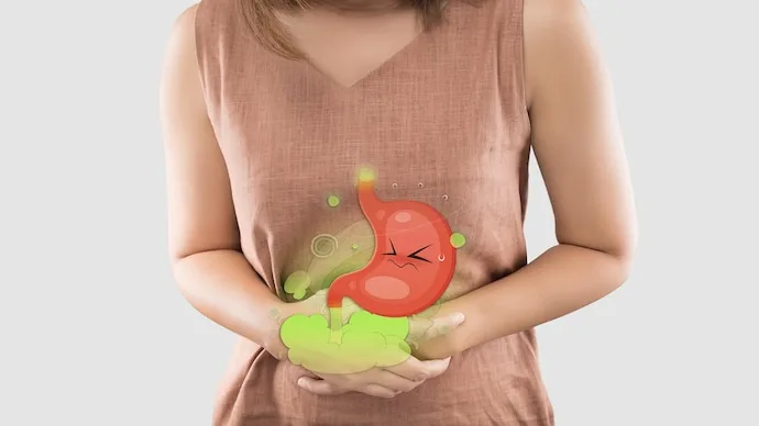 Person experiencing abdominal bloating and discomfort after eating a meal