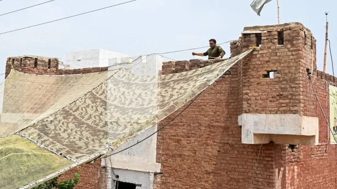 Pakistani security personnel install fishing nets over a police post in Khyber Pakhtunkhwa