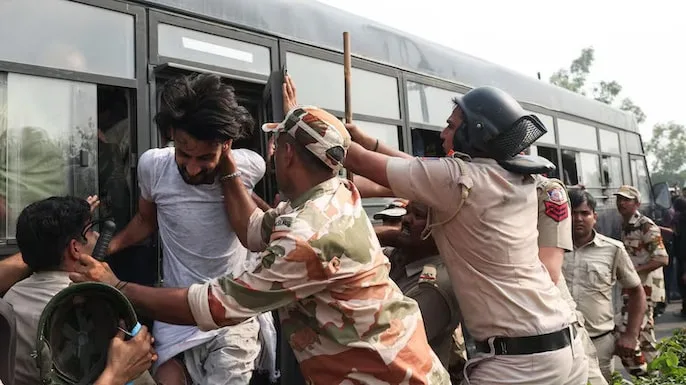 Security personnel detain protesters during the Cockroach Janta Party demonstration in Delhi over alleged electoral-roll irregularities.